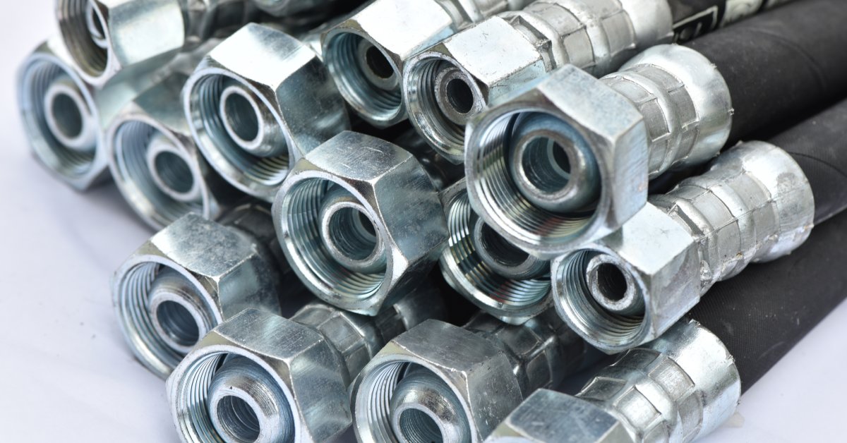 A group of several identical industrial hydraulic hoses bunched together against a plain white background.